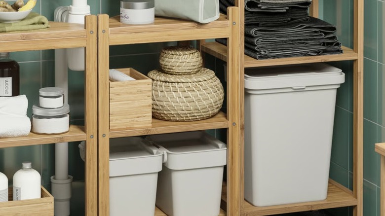 IKEA HÅLLBAR Bin tucked in bamboo bathroom shelves