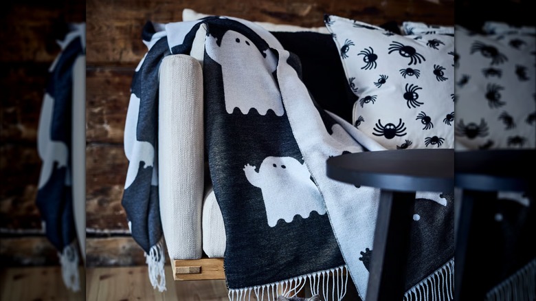 A black and white throw with ghosts all over it