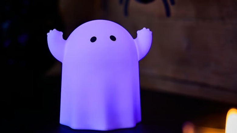 A ghost-shaped LED light glowing purple