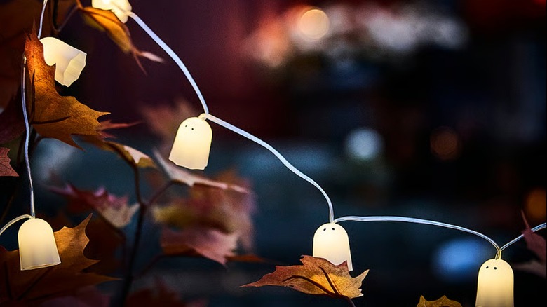 A string light with lit ghosts hanging from it