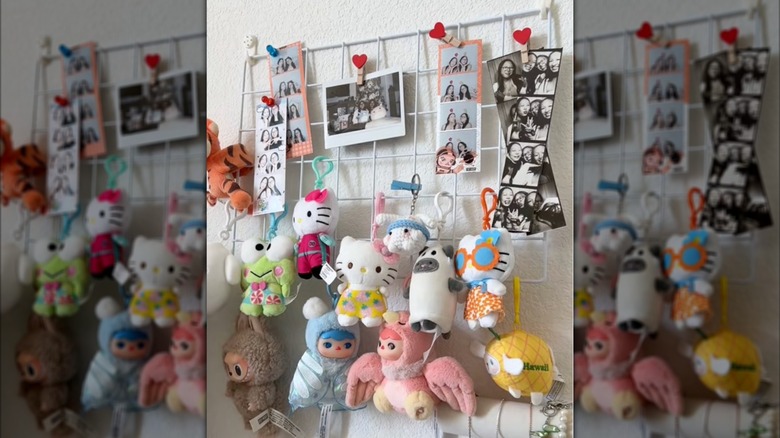 Key chains and photos hanging from a white wire rack