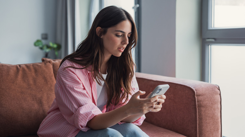 Unhappy person using a smartphone
