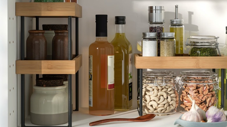 NÅLBLECKA shelves in a cabinet holding various jars of ingredients