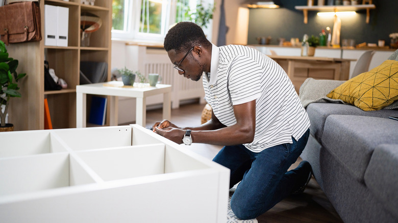 Man assembling IKEA bookcase