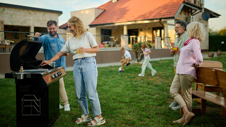 Family barbecuing and enjoying their backyard