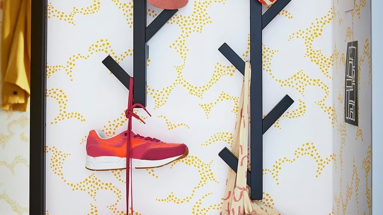 red shoes hanging on a black TJUSIG fixture on a wall