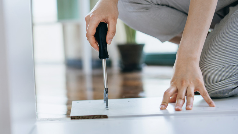 Woman assembling IKEA furniture