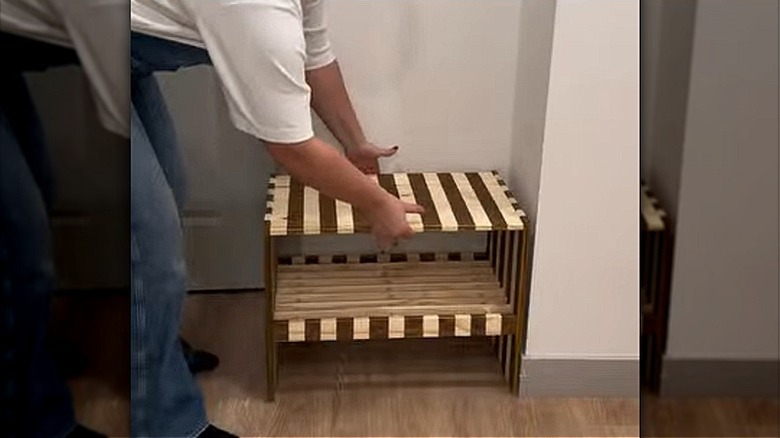 A DIYer reveals wood stain stripes on the IKEA RAGGBERG shoe bench