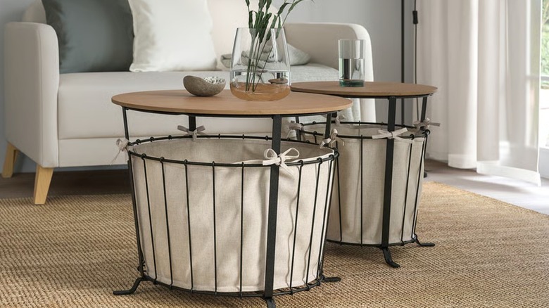 Two storage tables holding a vase and glass in a living room