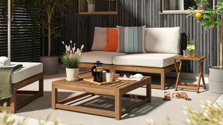 A beige loveseat placed on a covered patio