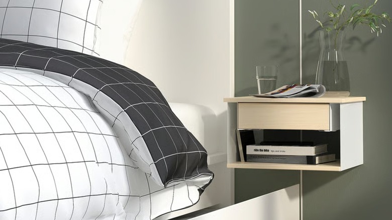 A small floating nightstand beside a bed