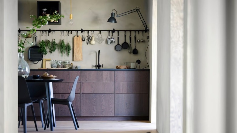 The HULTARP rail in a rustic kitchen used for decor and baking necessities