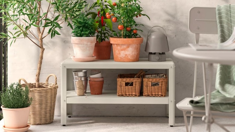 IKEA KOLBJÖRN Shelf on balcony to store plants, plant pots, and baskets full of tools