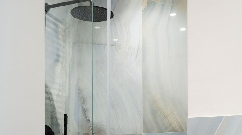 matte black showerhead in porcelain slab shower