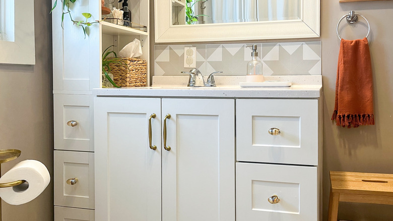 white bathroom vanity with Anthropologie-inspired Amazon hardware installed