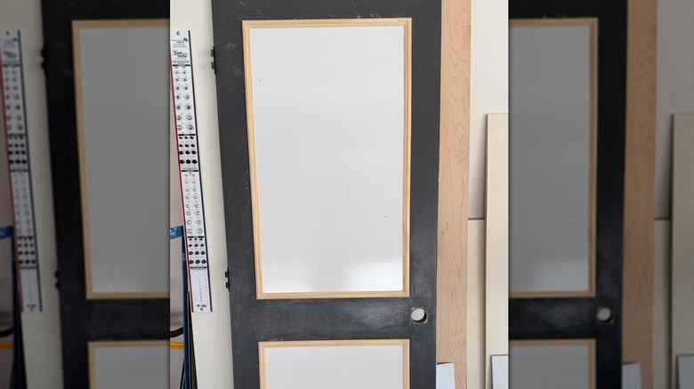 A process photo of modifying outdated interior doors with molding and MDF panels