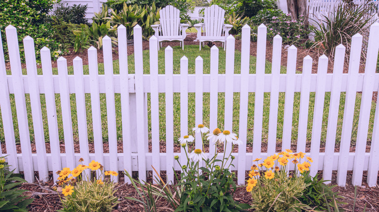 Fence with flowers and lawn furniture