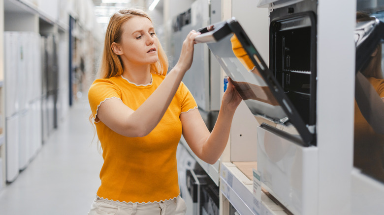 Woman shopping for a new oven