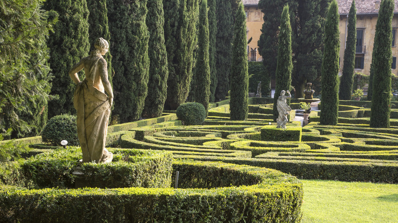 A formal Italian garden with evergreen hedges and statues