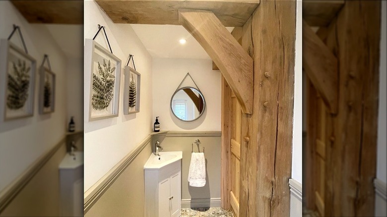 Small bathroom with a corner sink and accent walls painting in Drop Cloth by Farrow & Ball.