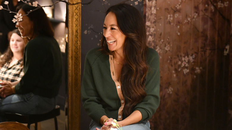 Interior designer Joanna Gaines sitting and laughing at book event