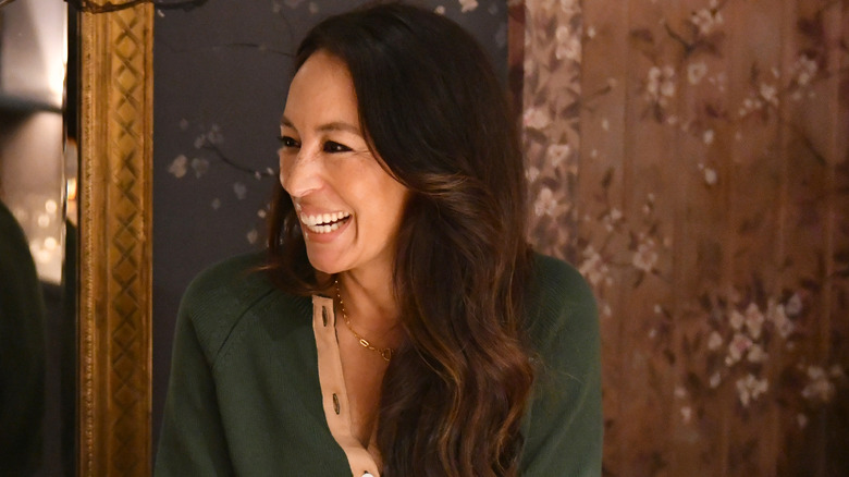 Joanna Gaines smiling, wearing green cardigan