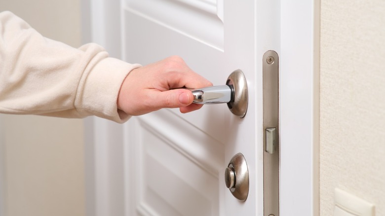 Person trying to open stuck interior door