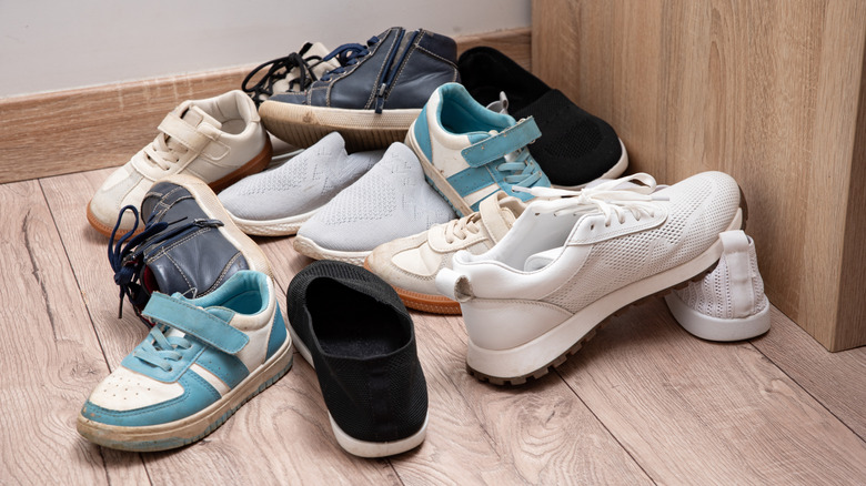 Pile of kids shoes scattered on the floor