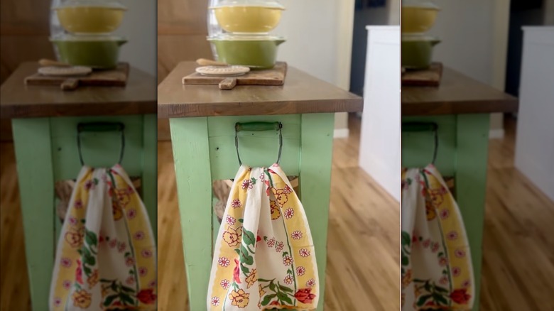 hands hanging towel on pastry cutter
