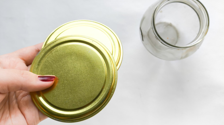 Woman holding jar lids