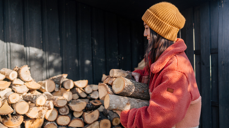 Woman stacking firewood