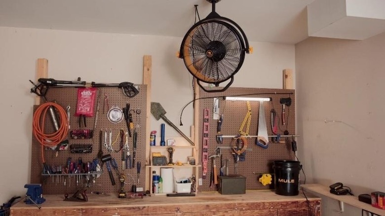 Mule 18-inch Garage Fan installed in garage near workshop table