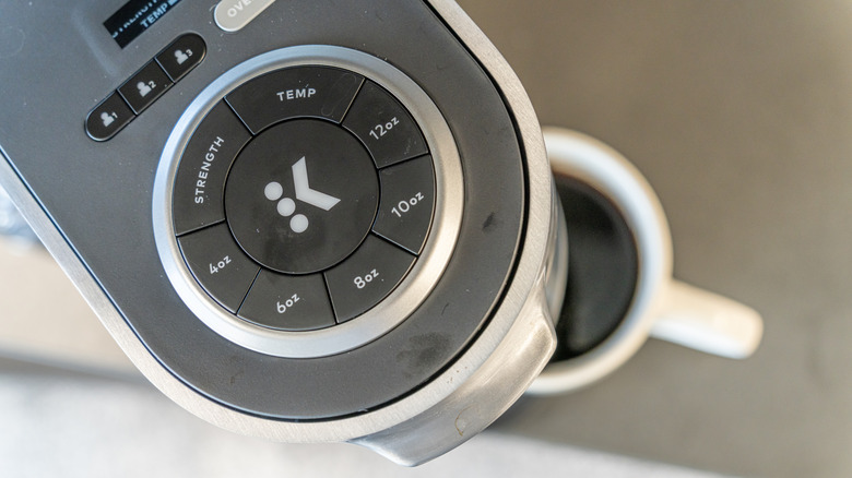 Close-up of the top of a Keurig coffeemaker and its size and setting buttons