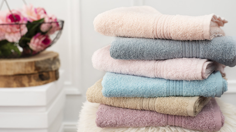 A stack of freshly laundered towels with roses