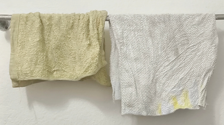 stiff damp towels hanging on towel bar