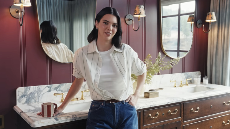 Kendall Jenner standing in her mountain house burgundy bathroom