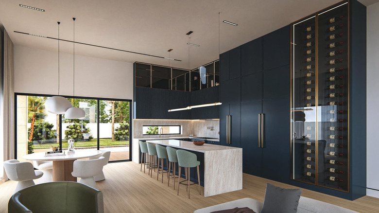 A unique kitchen features a wall of sleek navy floor-to-ceiling cabinets