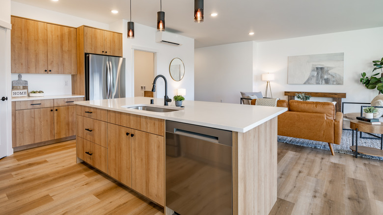Big kitchen island with built in dishwasher and sink