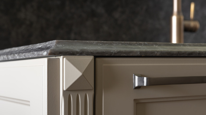 ogee countertop edge profile above cream-colored cabinetry