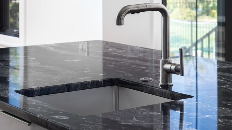 Modern kitchen with black marble countertop