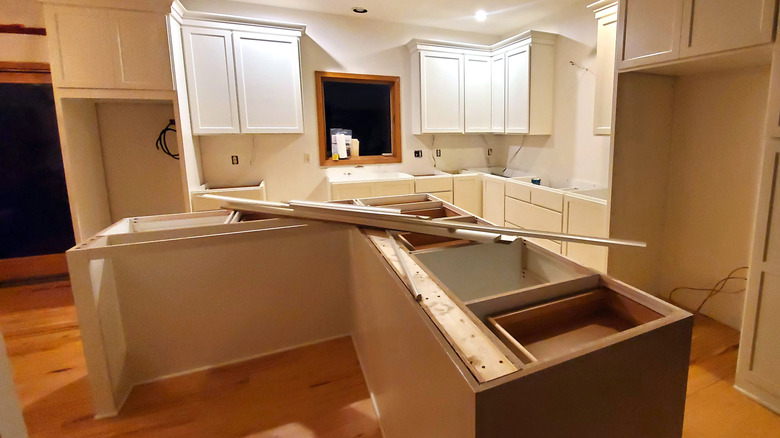 a kitchen under construction and awaiting new countertops