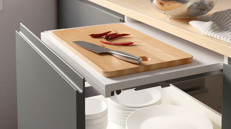 UTRUSTA Pull-out work surface installed within a drawer extended with cutting board on it
