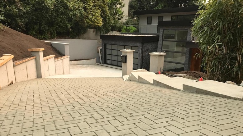 Stamped asphalt driveway leading to a modern home