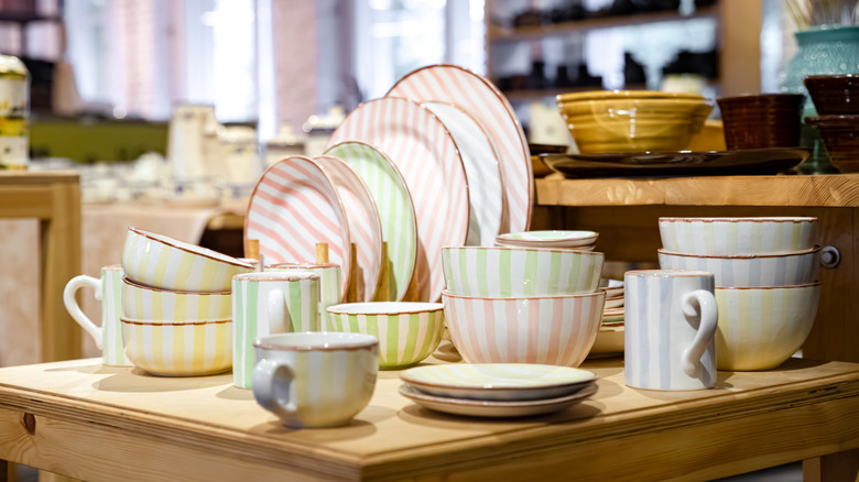 Plates and bowls stacked on a shelf.