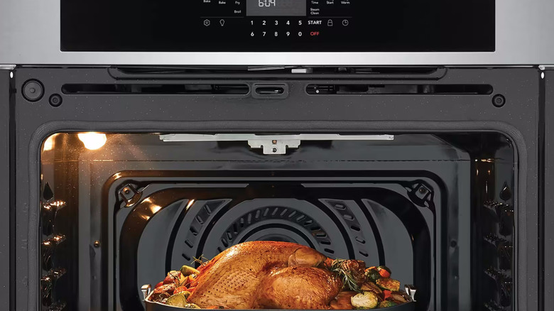 A cooked turkey inside a Frigidaire 30-inch electric wall oven with air fry