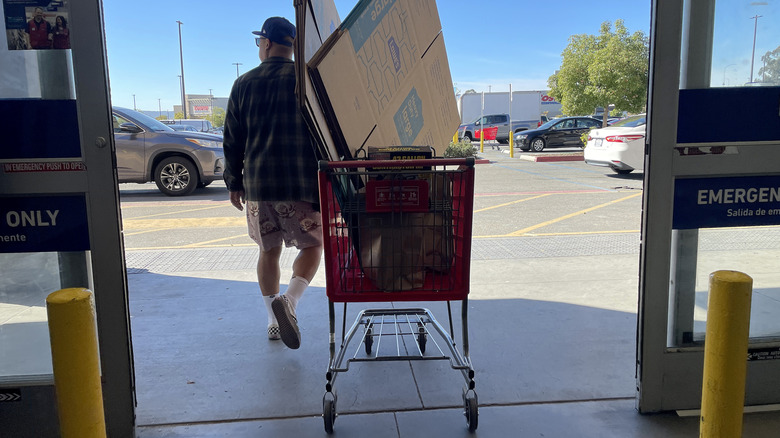 A customer pulls a full cart out of Lowe's