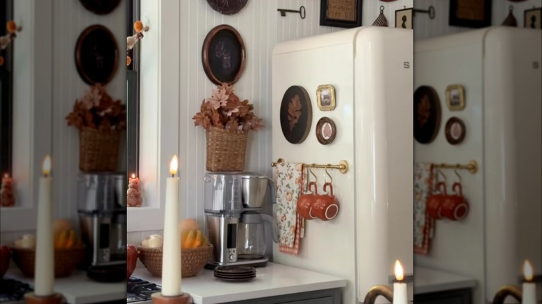 magnetic brass towel bar attached to the side of fridge for towels and hanging two mugs on S hooks