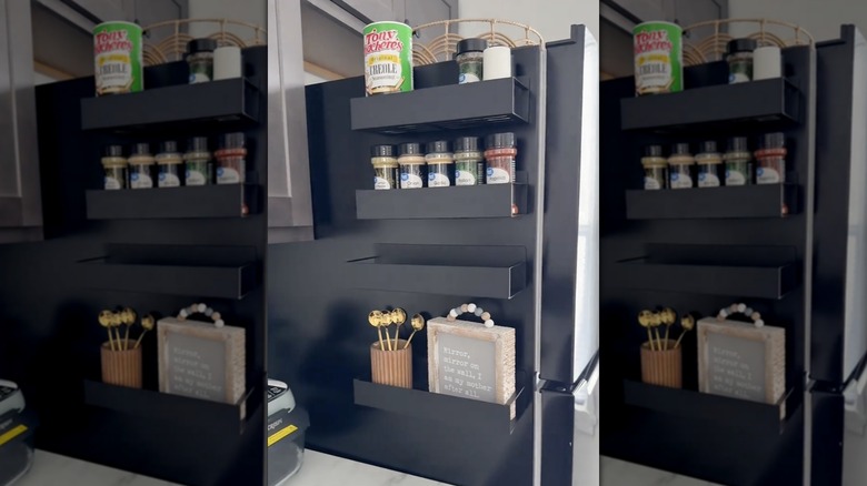A photo of black magnetic spice racks on a fridge with spice jars and accessories