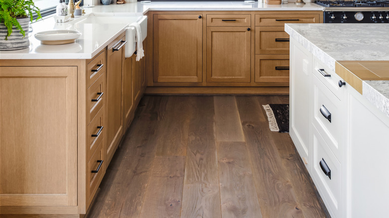 modern kitchen with natural wood perimeter cabinets and white island cabinets