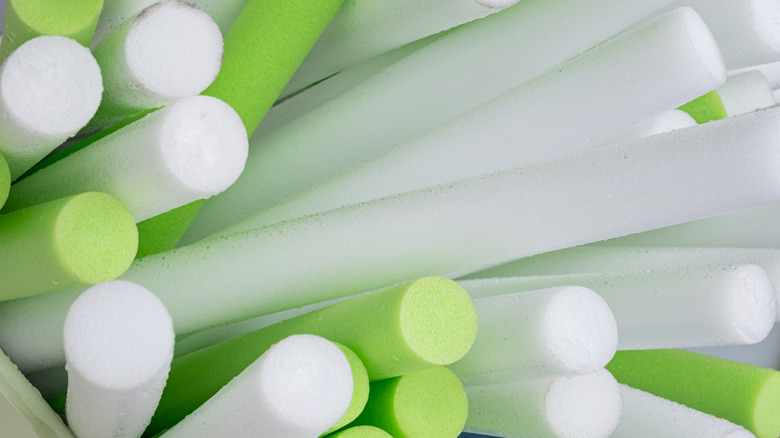 Green and white pool noodles